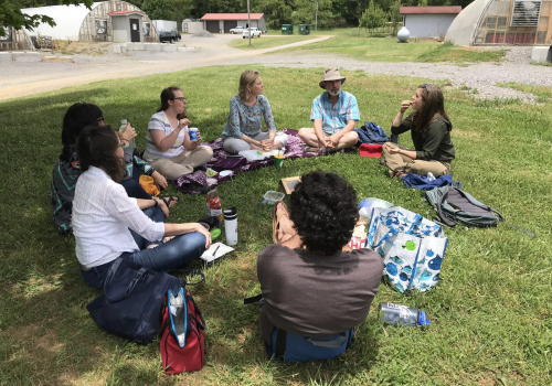Professors sitting in a circle during a discussion at a Faculty Learning Community.